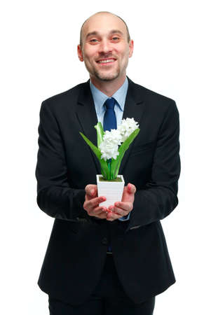 picture of handsome man with flower pot in handの写真素材