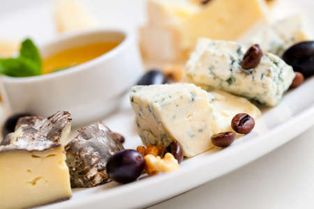 Still-life cheese platter with nuts and grapesの写真素材