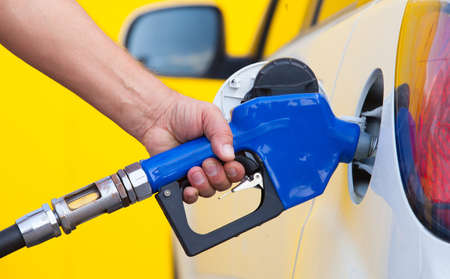 Closeup of man pumping gasoline fuel in car at gas stationの写真素材
