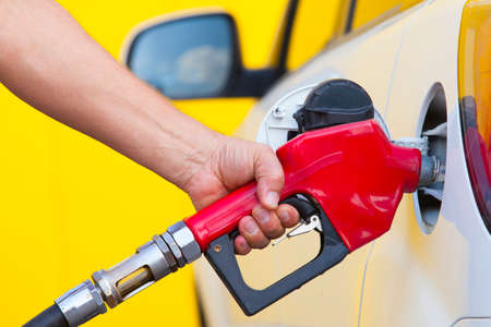 Closeup of man pumping gasoline fuel in car at gas stationの写真素材