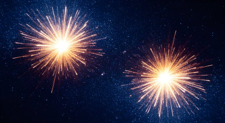 Two brilliant fireworks explode in a dazzling display against a dark, starfilled night sky, creating a festive and celebratory atmosphereの素材