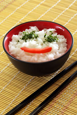 Chinese food in a black plate and sticksの写真素材