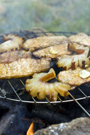 thick seasoned pork chops cooking on the grill in flames 