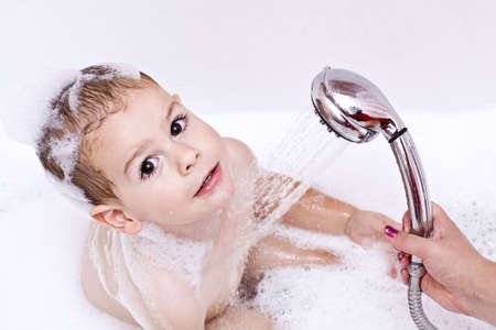 Boy playing with shower の写真素材