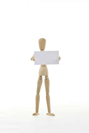 Mannequin holding up blank card isolated in white backgroundの写真素材