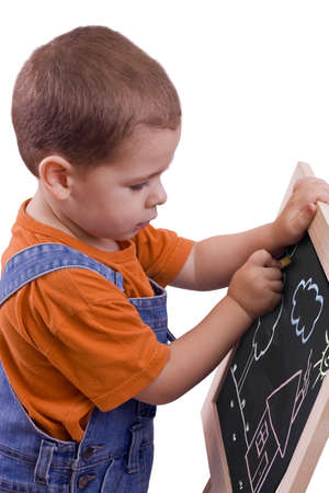 boy drawing on blackboard, isolated in whiteの写真素材