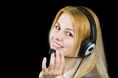 business customer support operator woman smiling - isolated in black の写真素材
