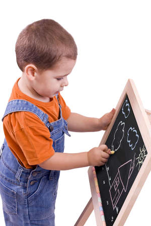 boy drawing on blackboard, isolated in whiteの写真素材