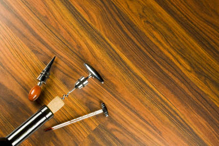 Opening a wine bottle with corkscrewの写真素材