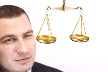 A business man holding a justice scale, isolated in white backgroundの写真素材