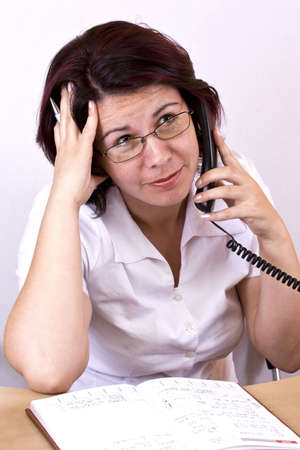 Helpful business woman with phone, studio shootの写真素材