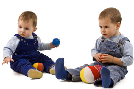 two adorable boys enjoy with colorful ballsの写真素材
