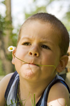 happy boy having fun outdoors , whit flowerの写真素材