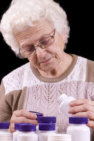 Too many pills to take isolated in black backgroundの写真素材