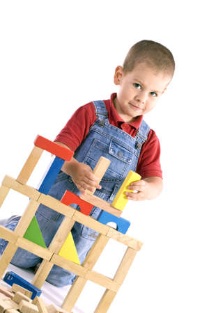 little boy playing with colorful wooden blocksの写真素材