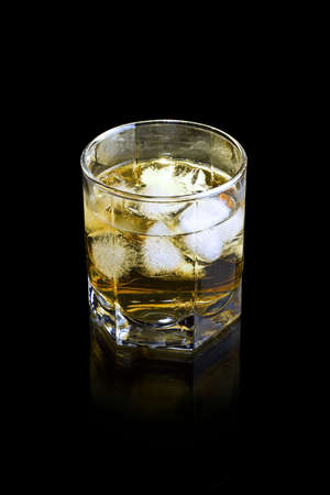 Whiskey in glass with ice cubesの写真素材