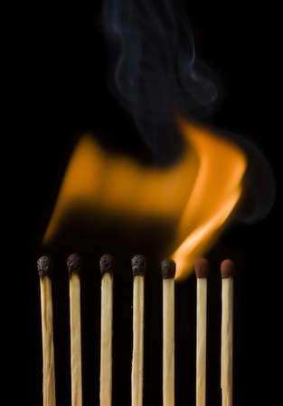 Burning match isolated in blackの写真素材