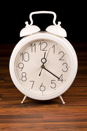white retro alarm clock in wood background