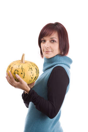 Young girl with a yellow pumpkin in her hands の写真素材