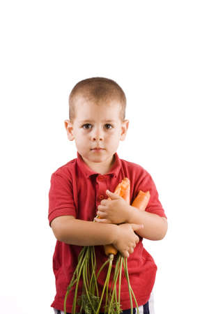 Boy holding fresh carrots isolated on white background の写真素材
