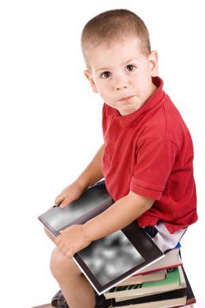 three year old boy sitting on pile of books, readingの写真素材