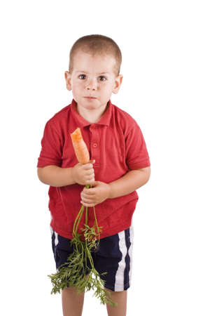 Boy holding fresh carrots isolated on white background の写真素材
