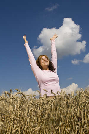 Young happy woman in field の写真素材