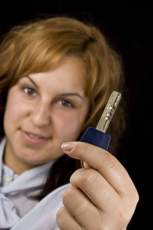 picture of happy woman with key over blackの写真素材
