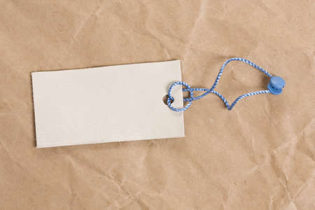 blank tag label, in background old crumpled paperの写真素材