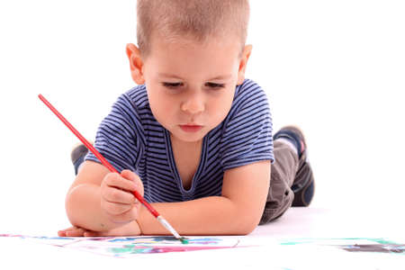 young boy painting over whiteの写真素材