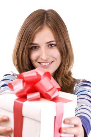 Girl holding a gift and smiling, isolated on white background. の写真素材