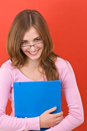 Female student isolated over a white background の写真素材