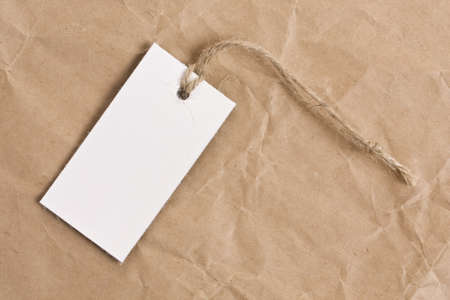 blank tag label, in background old crumpled paperの写真素材