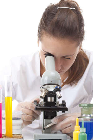 Woman working with a microscope in a lab の写真素材