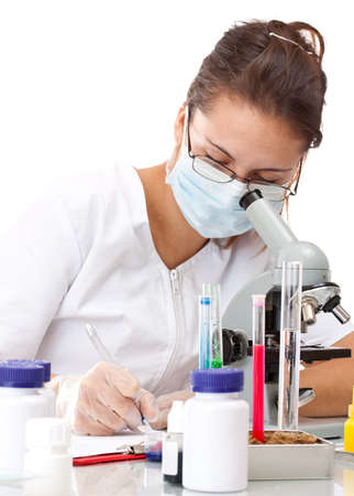 Serious female scientist writing on her clipboardの写真素材