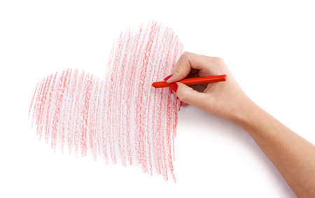 Hand with wax crayon drawing heart の写真素材