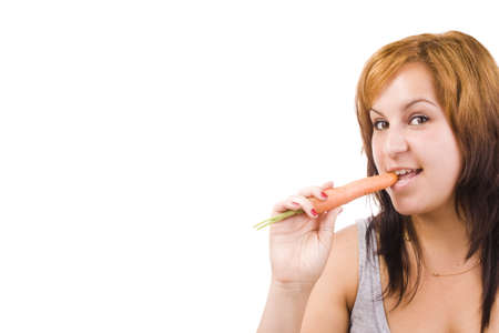 Face of young woman holding carrot. Isolated in whiteの写真素材