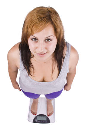woman on scales isolated in whiteの写真素材