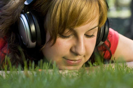 Pretty young girl listening music の写真素材