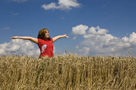 Young happy woman in field の写真素材