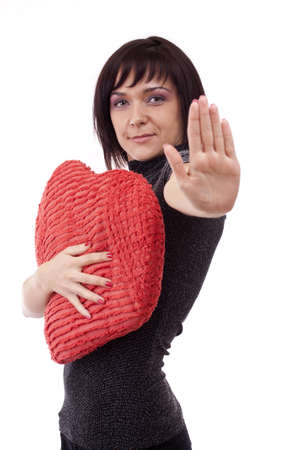 young woman showing stop sign with his hand, isolated on white backgrounの写真素材