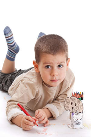 Little boy drawing with red pencilの写真素材