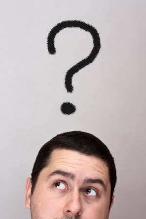 Male with a question mark over his headの写真素材