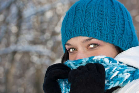 Cold winter woman covering her face in winter forest. の写真素材