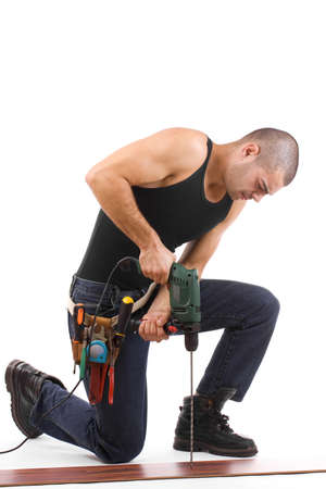 Closeup portrait of a young man drilling, isolated in whiteの写真素材
