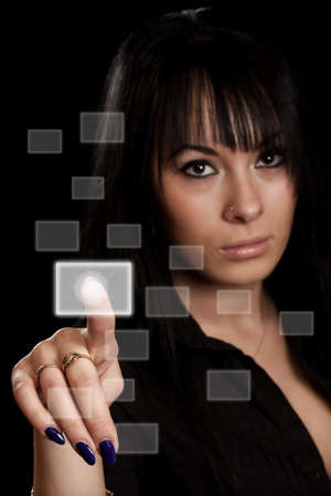 woman hand pressing digital buttons in black backgoundの写真素材