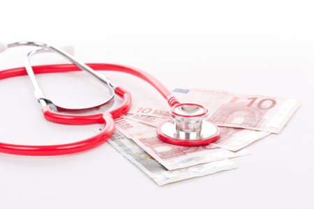 Red stethoscope is over euro money background. の写真素材