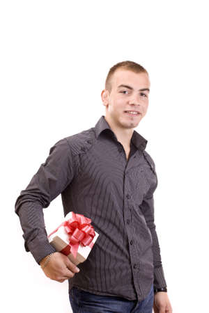 young man with a wrapped gift box for you (selective focus) の写真素材