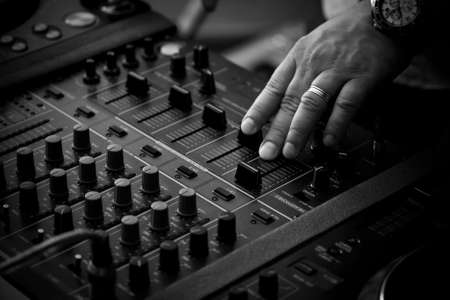 DJ playing music on professional mixing controllerの写真素材