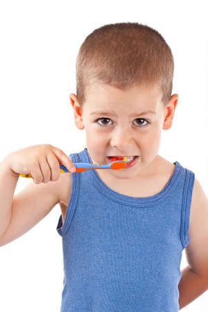 Young boy brushing his teeth with toothbrush, isolated in white